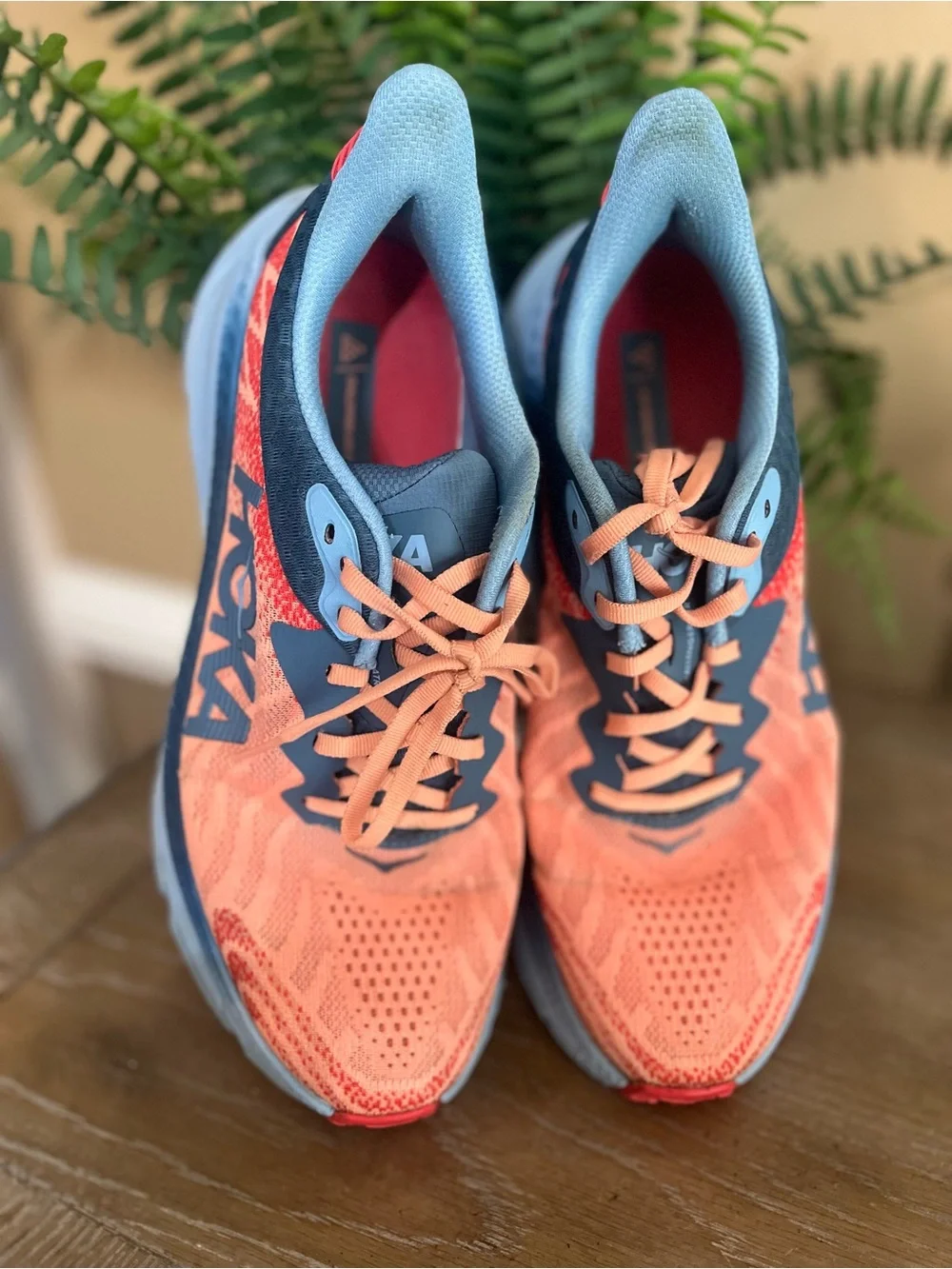 HOKA Women's Challenger ATR 7 sneakers feature a vibrant papaya orange mesh